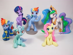 Size: 4032x3024 | Tagged: safe, artist:dustysculptures, imported from derpibooru, fluttershy, lyra heartstrings, princess celestia, rainbow dash, twilight sparkle, alicorn, pegasus, pony, unicorn, clothes, craft, duality, female, hoof on chin, mare, sculpture, sitting, unicorn twilight, uniform, wonderbolts uniform
