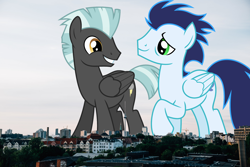 Size: 1900x1267 | Tagged: safe, artist:chainchomp2 edits, artist:thegiantponyfan, edit, imported from derpibooru, soarin', thunderlane, pegasus, pony, berlin, duo, folded wings, germany, giant pegasus, giant pony, grin, highrise ponies, irl, macro, male, mega giant, photo, ponies in real life, smiling, stallion, wings