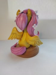 Size: 1532x2048 | Tagged: safe, artist:anotherdeadrat, fluttershy, pegasus, pony, craft, female, flower, mare, sculpture, sitting, smiling, spread wings, wings
