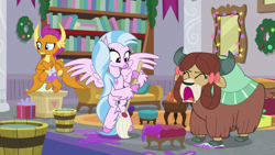 Size: 1279x719 | Tagged: safe, imported from derpibooru, screencap, silverstream, smolder, yona, classical hippogriff, dragon, hippogriff, yak, the hearth's warming club, bookshelf, bow, bucket, cloven hooves, colored hooves, crossed arms, hair bow, jewelry, monkey swings, mop, necklace, open mouth, raised eyebrow, screaming, string lights, trio