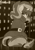 Size: 1780x2544 | Tagged: safe, artist:llametsul, imported from derpibooru, sunset shimmer, pony, unicorn, equestria girls, annoyed, belt, city, clothes, dress, female, horn, looking at you, looking back, looking back at you, mare, monochrome, signature, skirt, solo
