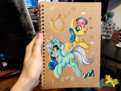 Size: 4096x3072 | Tagged: safe, artist:julunis14, imported from derpibooru, bon bon, lyra heartstrings, sweetie drops, earth pony, pony, unicorn, hand, irl, music notes, notebook, photo, traditional art