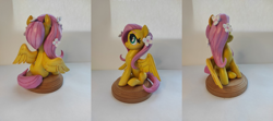 Size: 1813x808 | Tagged: safe, artist:anotherdeadrat, imported from derpibooru, fluttershy, pegasus, pony, craft, female, figurine, flower, flower in hair, irl, mare, photo, sculpture, sitting, smiling, solo