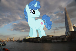 Size: 2048x1365 | Tagged: safe, artist:dashiesparkle edit, artist:jaredking779, edit, imported from derpibooru, party favor, pony, unicorn, england, giant pony, giant unicorn, highrise ponies, irl, london, macro, male, mega giant, photo, ponies in real life, smiling, solo, stallion, united kingdom