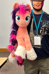 Size: 1184x1781 | Tagged: safe, artist:epicrainbowcrafts, imported from derpibooru, sunny starscout, earth pony, human, pony, convention, cropped, female, g5, irl, irl human, life size, mare, mask, photo, plushie, solo focus, trotcon, unshorn fetlocks