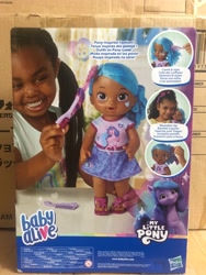 Size: 1500x2000 | Tagged: safe, imported from derpibooru, izzy moonbow, human, pony, unicorn, baby alive, dark skin, female, g5, irl, irl human, merchandise, photo, toy