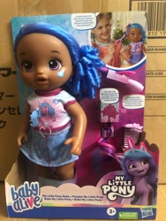 Size: 1500x2000 | Tagged: safe, imported from derpibooru, izzy moonbow, human, pony, unicorn, baby alive, dark skin, g5, irl, merchandise, official, photo, toy