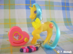 Size: 761x565 | Tagged: safe, imported from derpibooru, earth pony, pony, bead machine, beads, comb, female, g2, irl, mare, photo, raised hoof, smiling, solo, springly, tail, toy, unshorn fetlocks