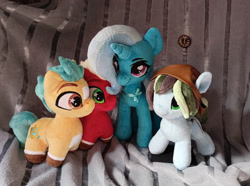 Size: 2560x1907 | Tagged: safe, artist:doctorkoda, artist:gingerale2016, artist:trueheartcraft, imported from derpibooru, photographer:jewellier, hitch trailblazer, sprout cloverleaf, trixie, oc, oc:dusty soil, earth pony, pony, unicorn, clock, clothes, g5, headscarf, irl, photo, pin, plushie, ribbon bow tie, scarf, size difference, stars, toy