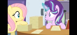 Size: 1600x720 | Tagged: safe, artist:agrol, imported from derpibooru, screencap, fluttershy, starlight glimmer, pegasus, unicorn, element of kindness, female, glowing, glowing horn, horn, looking at each other, looking at someone, paper, paperwork, quill, school of friendship, the element of kindness