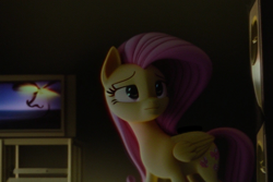 Size: 768x512 | Tagged: safe, imported from derpibooru, fluttershy, pegasus, pony, ai content, ai generated, blurry background, eyes open, pink hair, pink mane, realistic, room, sad, sad face, solo, television