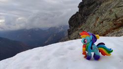 Size: 1192x670 | Tagged: safe, artist:mgrdash, imported from derpibooru, rainbow dash, pegasus, pony, clothes, endangering plushies, irl, mountain, photo, plushie, ponies in real life, snow