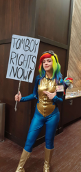 Size: 1956x4128 | Tagged: safe, imported from derpibooru, rainbow dash, human, bodysuit, boots, clothes, cosplay, costume, epic, form fitting, goggles, goggles on head, irl, irl human, photo, plushie, pointing, shoes, sign, solo, tomboy, uniform, wig, wonderbolts uniform