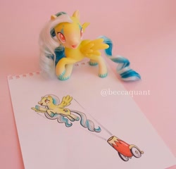 Size: 1080x1036 | Tagged: safe, artist:beccaintoyland, imported from derpibooru, oc, unnamed oc, pegasus, pony, cannon, circus, clown, copic, curly mane, customized toy, drawing, facial markings, g4, g4.5, irl, party cannon, photo, pony cannonball, red eyes, solo, toy, traditional art