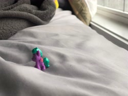 Size: 4032x3024 | Tagged: safe, imported from derpibooru, sunshower raindrops, pegasus, pony, bedsheets, blanket, curtains, g5, irl, male, maverick mauve, mini world magic, photo, side view, smol, solo, stallion, toy, window, windowsill