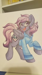 Size: 1152x2048 | Tagged: safe, artist:inkkeystudios, imported from derpibooru, oc, oc only, oc:stutter steps, pegasus, pony, badge, clothes, eye clipping through hair, glasses, hoodie, looking at you, open mouth, open smile, photo, smiling, solo, traditional art