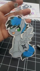 Size: 1152x2048 | Tagged: safe, artist:inkkeystudios, imported from derpibooru, oc, oc only, pegasus, pony, badge, eye clipping through hair, looking at you, open mouth, open smile, photo, sitting, smiling, solo, spread wings, traditional art, wings