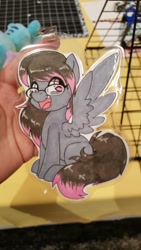 Size: 1152x2048 | Tagged: safe, artist:inkkeystudios, imported from derpibooru, oc, oc only, pegasus, pony, badge, eye clipping through hair, glasses, happy, looking at you, open mouth, open smile, photo, sitting, smiling, solo, spread wings, traditional art, wings