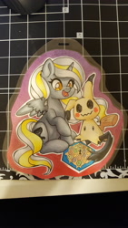 Size: 5312x2988 | Tagged: safe, artist:inkkeystudios, imported from derpibooru, alicorn, mimikyu, pony, badge, board game, open mouth, open smile, photo, pokémon, smiling, spread wings, traditional art, wings