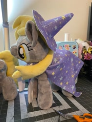 Size: 1536x2048 | Tagged: safe, artist:hibiscusstitch, imported from derpibooru, derpy hooves, pegasus, pony, accessory swap, cape, clothes, female, irl, photo, plushie, solo, trixie's cape