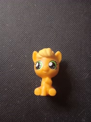 Size: 3120x4160 | Tagged: safe, imported from derpibooru, photographer:hollyn, applejack, earth pony, pony, baby, baby pony, babyjack, foal, photo, solo, toy, younger