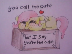 Size: 640x480 | Tagged: safe, artist:fluttersdoodles, imported from derpibooru, fluttershy, blushing, box, cute, heart, hooves on face, lying down, paper, shyabetes