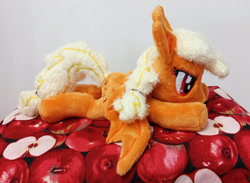 Size: 3182x2324 | Tagged: safe, artist:basil_leafeon, imported from derpibooru, applejack, bat pony, pony, applebat, bat ponified, bat wings, beanie (plushie), female, irl, lying down, mare, photo, plushie, prone, race swap, wings