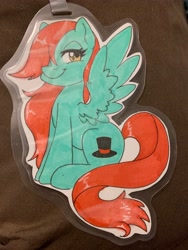 Size: 3024x4032 | Tagged: safe, artist:inkkeystudios, imported from derpibooru, oc, oc only, pony, badge, hair over one eye, lidded eyes, looking at you, photo, sitting, smiling, solo, spread wings, traditional art, wings