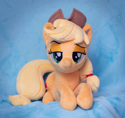 Size: 2939x2780 | Tagged: safe, artist:buttercupbabyppg, imported from derpibooru, applejack, earth pony, pony, applejack's hat, cowboy hat, female, hair tie, hat, irl, lidded eyes, lying down, mare, photo, plushie, prone, solo