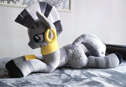 Size: 2048x1428 | Tagged: safe, artist:mdcraft10, imported from derpibooru, zecora, zebra, ear piercing, earring, female, indoors, irl, jewelry, lying down, mare, photo, piercing, plushie, prone, solo