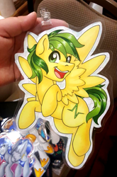 Size: 677x1025 | Tagged: safe, artist:inkkeystudios, imported from derpibooru, oc, oc only, pegasus, pony, badge, eye clipping through hair, flying, looking at you, open mouth, open smile, photo, smiling, solo, spread wings, traditional art, wings