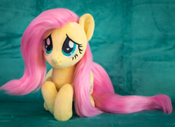 Size: 1984x1446 | Tagged: safe, artist:buttercupbabyppg, imported from derpibooru, fluttershy, pegasus, pony, cute, female, folded wings, irl, lying down, mare, photo, plushie, prone, shyabetes, smiling, solo, wings