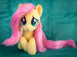 Size: 1852x1371 | Tagged: safe, artist:buttercupbabyppg, imported from derpibooru, fluttershy, pegasus, pony, cute, female, folded wings, irl, lying down, mare, photo, plushie, prone, shyabetes, smiling, solo, wings