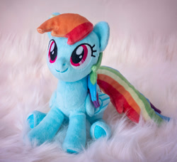 Size: 1053x962 | Tagged: safe, artist:buttercupbabyppg, imported from derpibooru, rainbow dash, pegasus, pony, female, folded wings, irl, mare, photo, plushie, sitting, smiling, solo, wings