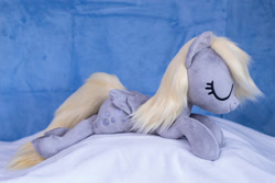 Size: 1511x1010 | Tagged: safe, artist:buttercupbabyppg, imported from derpibooru, derpy hooves, pegasus, pony, eyes closed, female, folded wings, happy, irl, lying down, mare, photo, plushie, prone, sleeping, wings