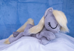 Size: 1382x950 | Tagged: safe, artist:buttercupbabyppg, imported from derpibooru, derpy hooves, pegasus, pony, eyes closed, female, folded wings, happy, irl, lying down, mare, photo, plushie, prone, sleeping, wings