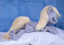 Size: 1415x990 | Tagged: safe, artist:buttercupbabyppg, imported from derpibooru, derpy hooves, pegasus, pony, eyes closed, female, folded wings, happy, irl, lying down, mare, photo, plushie, prone, sleeping, wings