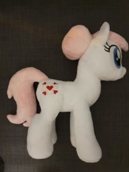 Size: 240x320 | Tagged: safe, artist:melodisde, imported from derpibooru, nurse redheart, earth pony, pony, bun, female, happy, irl, mare, photo, plushie, smiling, solo, standing