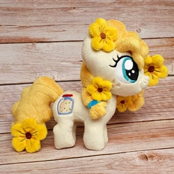 Size: 1200x1200 | Tagged: safe, artist:straycatcrafts, imported from derpibooru, pear butter, earth pony, female, filly, flower, foal, hair tie, happy, irl, photo, plushie, smiling, solo, younger