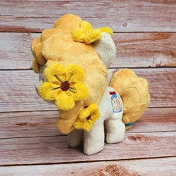 Size: 1200x1200 | Tagged: safe, artist:straycatcrafts, imported from derpibooru, pear butter, earth pony, female, filly, flower, foal, hair tie, happy, irl, photo, plushie, smiling, solo, younger