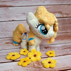 Size: 1200x1200 | Tagged: safe, artist:straycatcrafts, imported from derpibooru, pear butter, earth pony, female, filly, flower, foal, hair tie, happy, irl, photo, plushie, smiling, solo, younger