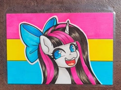 Size: 2491x1839 | Tagged: safe, artist:inkkeystudios, imported from derpibooru, pony, unicorn, badge, bow, hair bow, happy, looking at you, open mouth, open smile, pansexual pride flag, photo, pride, pride flag, smiling, solo, traditional art