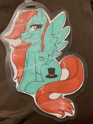 Size: 3024x4032 | Tagged: safe, artist:inkkeystudios, imported from derpibooru, oc, oc only, pony, badge, hair over one eye, lidded eyes, looking at you, photo, sitting, smiling, solo, spread wings, traditional art, wings