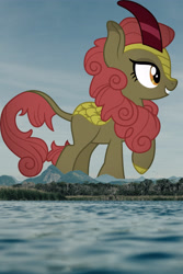 Size: 3072x4608 | Tagged: safe, artist:cloudy glow, edit, editor:jaredking779, imported from derpibooru, maple brown, kirin, background kirin, cloven hooves, female, giantess, grin, high res, highrise ponies, irl, macro, mountain, mountain range, photo, ponies in real life, raised hoof, smiling, solo
