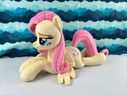 Size: 4032x3024 | Tagged: safe, artist:kazzysart, imported from derpibooru, fluttershy, pony, irl, lidded eyes, lying down, photo, plushie, prone, solo