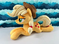 Size: 4032x3024 | Tagged: safe, artist:kazzysart, imported from derpibooru, applejack, pony, irl, lidded eyes, lying down, photo, plushie, prone, solo