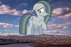 Size: 6048x4024 | Tagged: safe, artist:gamemasterluna, edit, editor:jaredking779, imported from derpibooru, marble pie, earth pony, pony, absurd resolution, cute, female, floppy ears, giant pony, giantess, hair over one eye, highrise ponies, irl, macro, marblebetes, mare, mountain, mountain range, photo, ponies in real life, raised hoof, smiling, solo