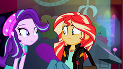 Size: 3072x1727 | Tagged: safe, imported from derpibooru, screencap, starlight glimmer, sunset shimmer, human, equestria girls, mirror magic, spoiler:eqg specials, beanie, canterlot mall, cinema, clothes, duo, duo female, female, frown, geode of empathy, hat, jacket, jewelry, leather, leather jacket, looking at each other, looking at someone, magical geodes, necklace