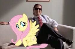 Size: 840x543 | Tagged: safe, edit, imported from derpibooru, fluttershy, human, pony, american psycho, couch, crossover, duo, female, irl, irl human, male, mare, patrick bateman, photo, smiling, sunglasses