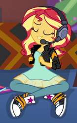 Size: 267x429 | Tagged: safe, imported from derpibooru, screencap, sunset shimmer, human, equestria girls, equestria girls series, game stream, spoiler:eqg series (season 2), clothes, couch, cropped, dress, gamer sunset, headphones, jacket, leather, leather jacket, pants, solo, sunset's apartment, trainers